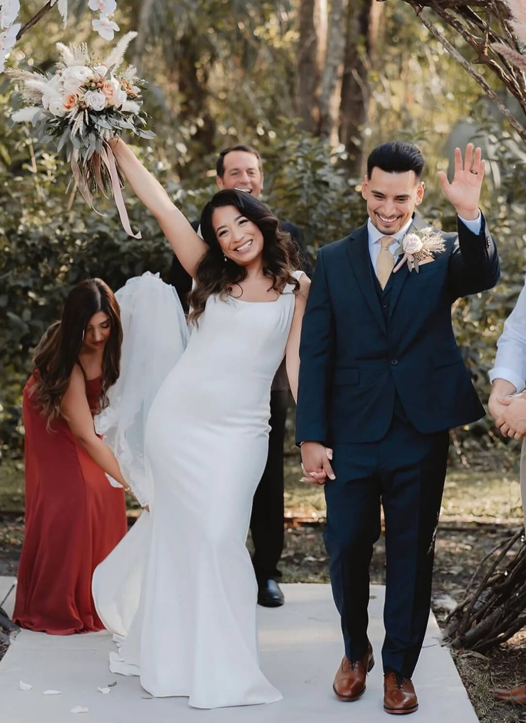 bride and groom happily walking down the aisle